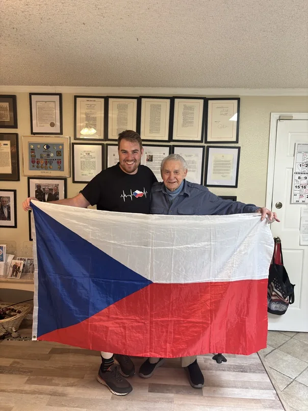 Harvey Drahos and historian Jiri Kluc holding a Czech flag.