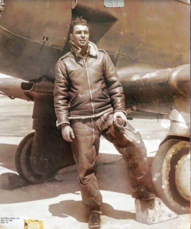 Len Zerlin in flying gear beside a military aircraft during the Second World War.