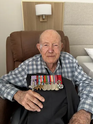 Bill Purdy holding his wartime medals.