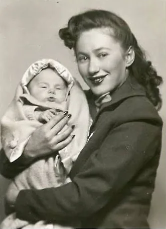 A historical photograph of Renée Firestone holding a baby.